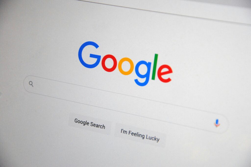 Close-up of the Google homepage on a screen showing search options.